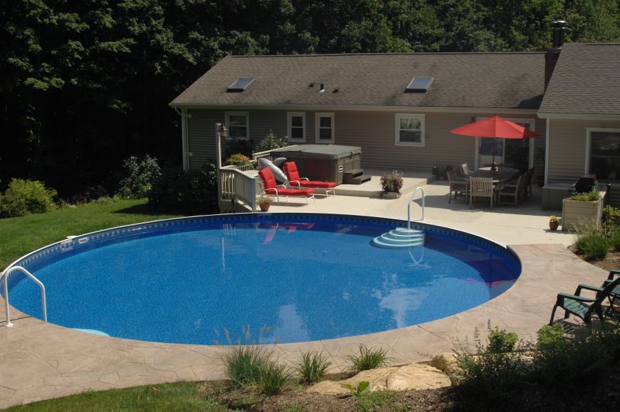 Above ground pool installation with finished edge treatment and surrounding surfaces